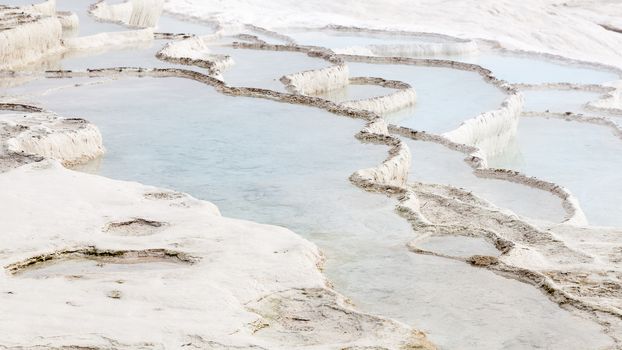 The view across a white travertine hot spring in Pamukkale, southwestern Turkey.  The site is a UNESCO World Heritage Site.