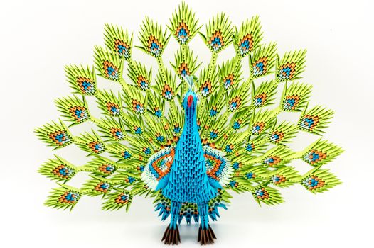 Male paper peacock in front of a white background