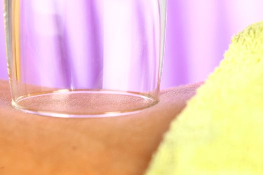 close up of body parts of a woman at wellness center with purple background