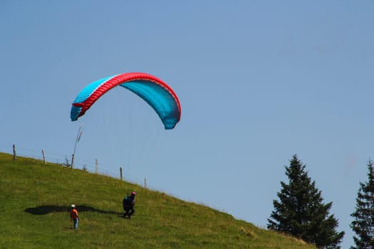 para gliding somewhere in the alps with blue sky