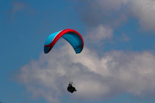 para gliding somewhere in the alps with blue sky