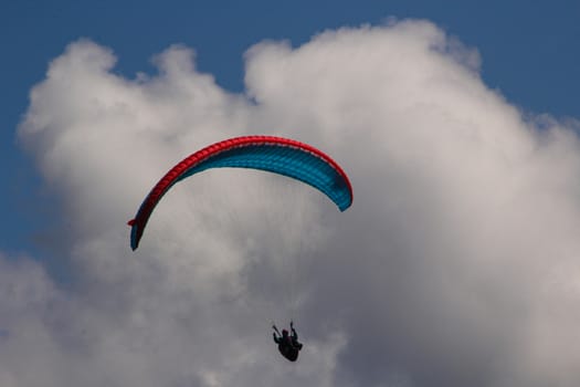 para gliding somewhere in the alps with blue sky