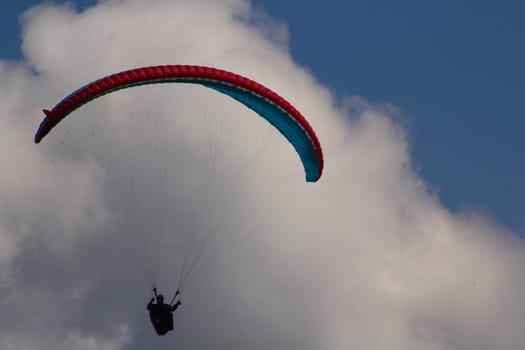 para gliding somewhere in the alps with blue sky