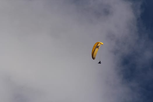 para gliding somewhere in the alps with blue sky