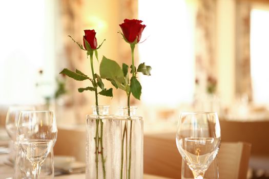 red roses on table set for guest to arrive in a restaurant