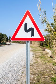 A street sign in southern Turkey indicating that a winding road is ahead.