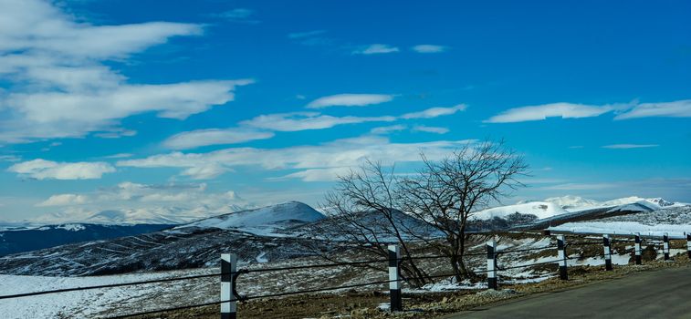 Blue winter sky and road in mountain, winter time in Caucasus mountain range close to Tbilisi, Georgia