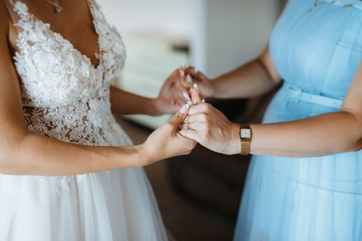 bride holds mom's hands