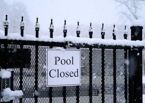 Sign on gate for Pool Closed in Snow