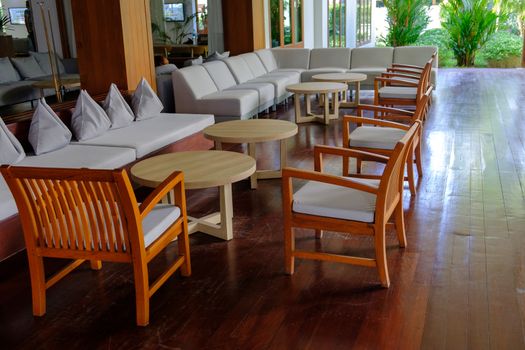 Terrace lounge with Comfortable pillow on sofa and chairs decoration. Outdoor patio in a luxury resort.  