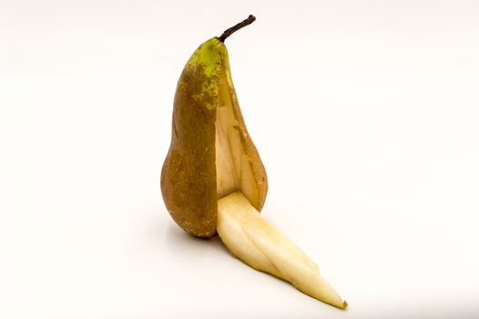 Pear standing with a cut out piece on a white background