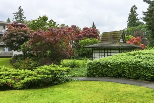 Asphalt pathway over small park in residential area