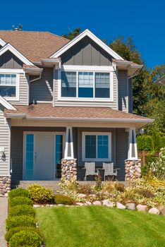 Entrance of luxury house with green grass lawn in front