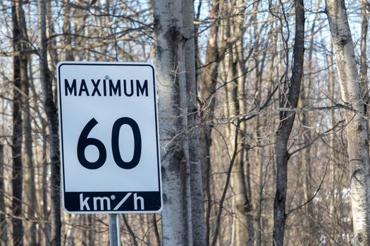A speed limit road sign in Ontario, Canada has a posted maximum of 60 km/h, or sixty kilometers per hour.