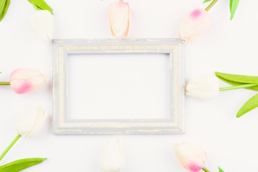 Happy Women's Day, Mother's Day and Valentine's Day concept. top view flat lay Tulip flower and photo frame on white background, copy space for your text