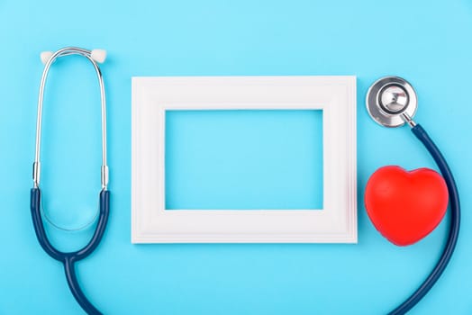 Doctor's Day concept, flat lay top view, stethoscope with photo frame diagnosis of heart disease on blue background with copy space for text