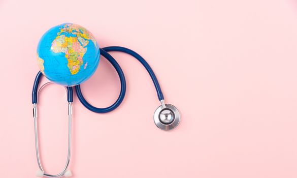 World health day concept, Stethoscope, globe on pink background with copy space. Global health care