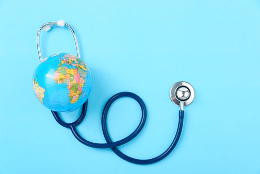 World health day concept, Stethoscope, globe on blue background with copy space. Global health care