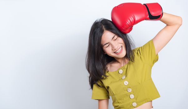 Portrait Asian beautiful young woman standing smile in boxing gloves and looking to camera, shoot the photo in a studio on a white background, There was copy space