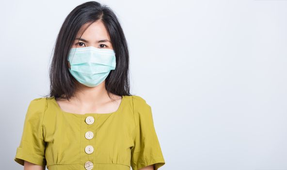 Portrait Asian beautiful happy young woman wearing face mask protects filter dust pm2.5 anti-pollution, anti-smog and air pollution on a white background, with copy space