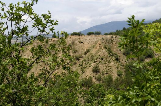 A view of the neighboring slope with new Stops pyramids of yellow rock formations, west share of Rila mountain, Kyustendil region, Bulgaria, Europe