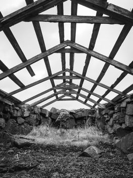 Boat house in Iceland old structure in West fjords roof blown away in black and white
