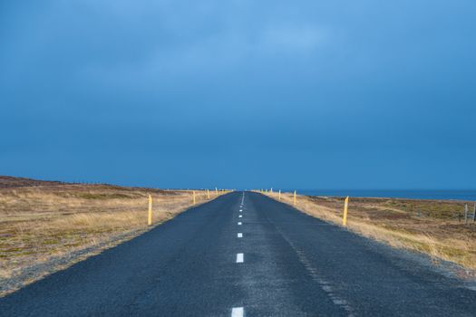 Empty coast road in Iceland during grey and stormy autumn day