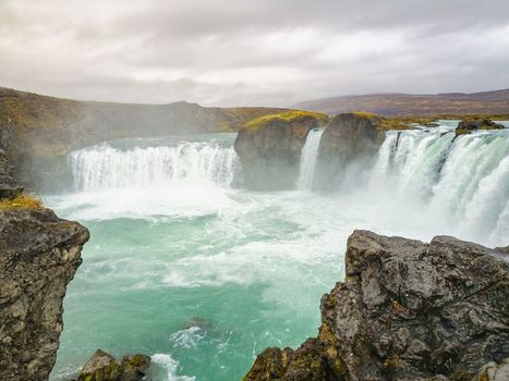 Godafoss waterfall in Iceland plunge pool full of turquoise water in autumn