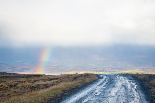 Mountain pass towards Akureyri in Iceland rainbow appearing inside valley