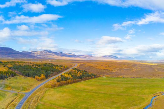 Northern Iceland during autumn aerial photo of trees and landscape turning yellow during sunny weather