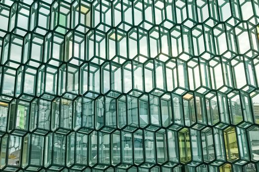 Reykjavik in Iceland city seen through modern facade of the concert hall harpa