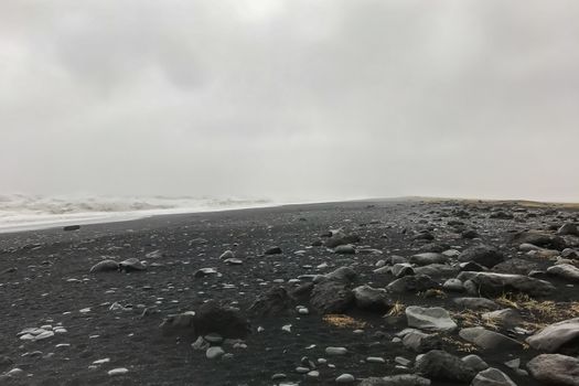 Reynisfjara Beach next to Reynisdrangar during stormy weather and heavy rain
