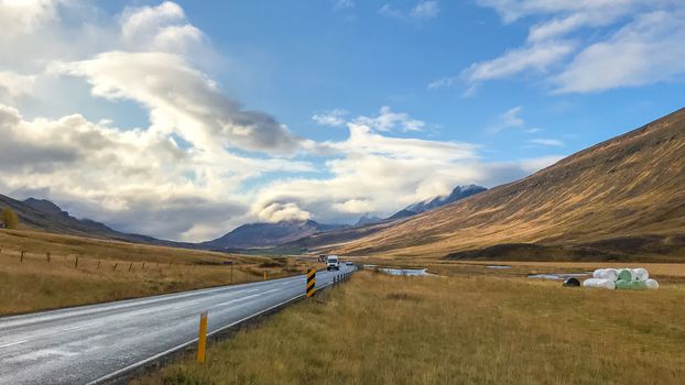 Road in north Iceland leading through valley during sunshine