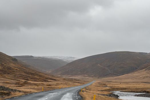 Road trip in Iceland driving over empty road during rainy weather close to West fjords