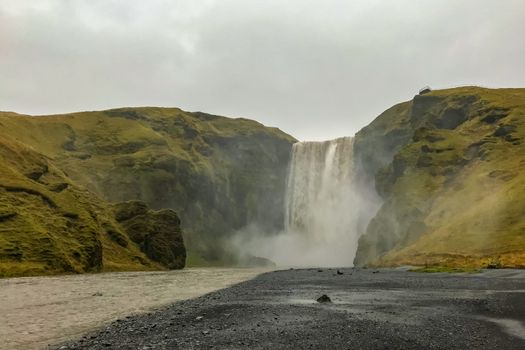 Skogafoss waterfall in Iceland during heavy rain and stormy weather