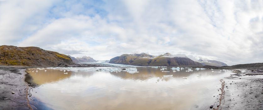 Vatnajoekull glacier in Iceland panorama of glacier lake ice floes drifting around