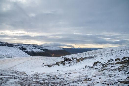 West fjords of Iceland icy mountain road above the snow line during autumn