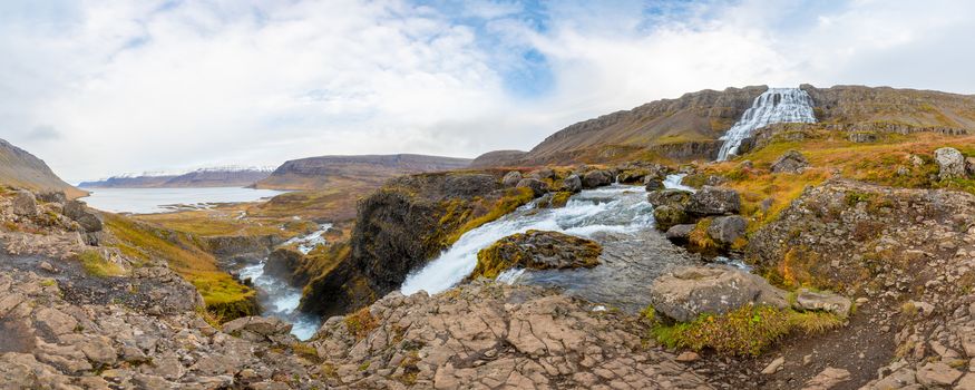 West fjords of Iceland Göngummanafoss and Dynjandi waterfall panorama of fall and the snow covered fjord