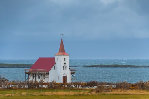 Wooden church in Iceland close to Atlantic coast during storm weather