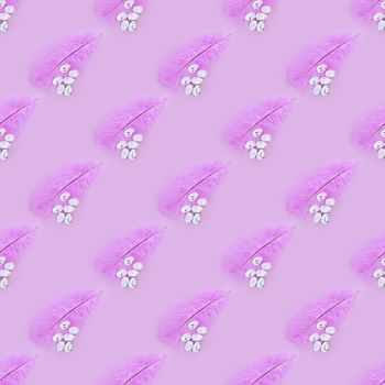 Seamless texture of pink feather and eggs on a pink background. Easter concept