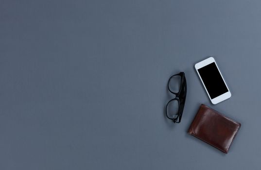 Office desktop with wallet, cell phone and reading glasses 