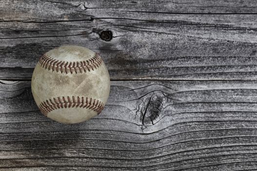 Old used baseball on rustic wooden background. Baseball sports concept with copy space