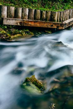 Small forest river flowing through rocks and boulders