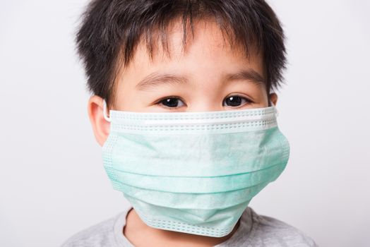 Closeup Asian face, Little children boy sick he using medicine healthcare mask on white background with copy space, health medical care