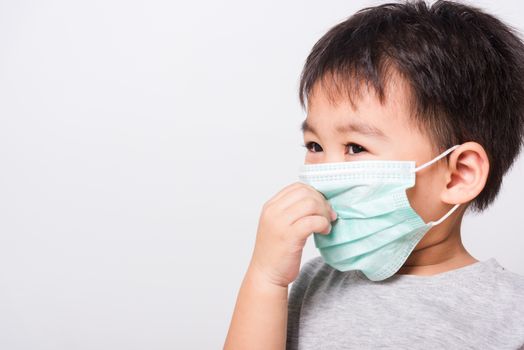 Closeup Asian face, Little children boy sick he using medicine healthcare mask on white background with copy space, health medical care