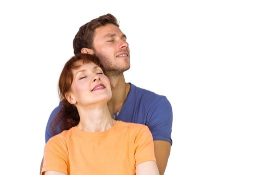 Happy couple together looking upwards on white background