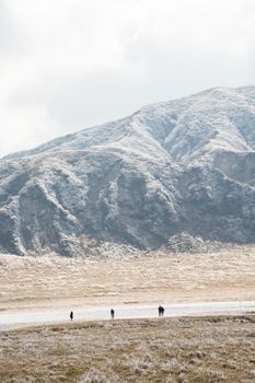 Mount Aso and Kusasenri in winter. covered by golden yellow grassland - Kumamoto, Japan