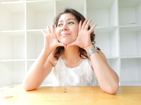 Beautiful woman smiling happy against white background.
