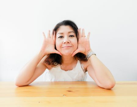 Beautiful woman smiling happy against white background.
