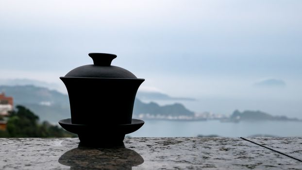 The classic Taiwanese tea cup on top of wall with sea view at Jiufen old street in Taiwan.